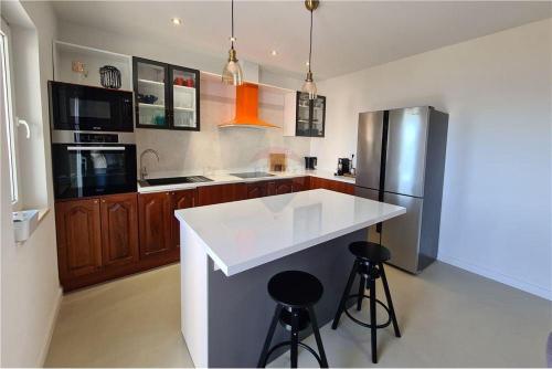 a kitchen with a white counter and a refrigerator at Apartment Capitano in Slatine