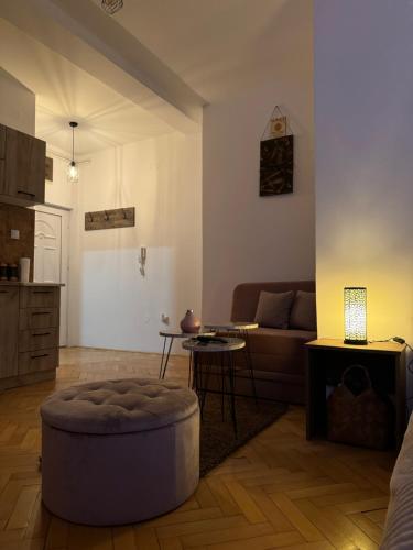 a living room with a couch and a table at Loli apartman 2 in Kraljevo