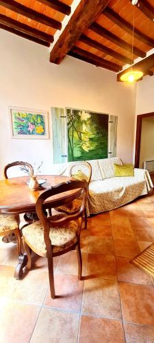 a bedroom with a bed and a wooden table and chairs at Flat Ghino di Tacco historical centre Radicofani in Radicofani