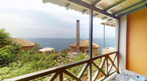 a balcony with a view of the ocean at Vrachokipos in Souvala