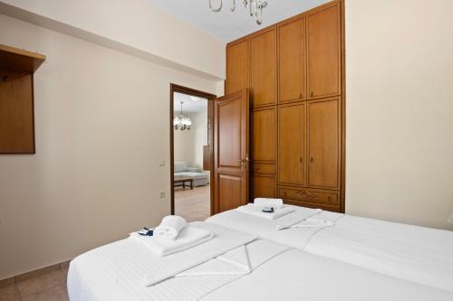 a bedroom with a large white bed and a mirror at Delta Sea View House in Plataniás