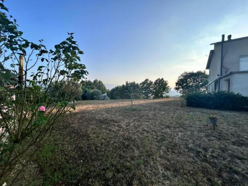 an empty yard next to a white building at Residence San Martino in Busso