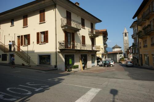 a building with a clock tower on a street at Peter Schubert in Baveno