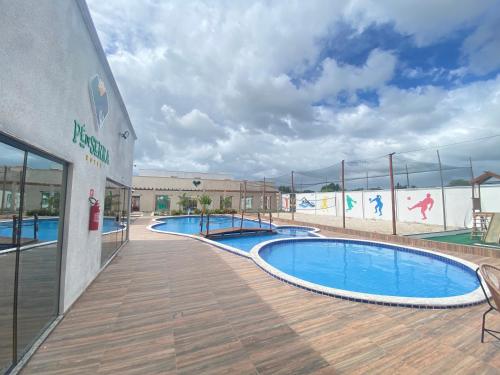 a swimming pool in a building with a basketball court at Hotel Pé de Serra Piranhas in Piranhas
