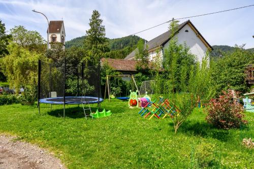 a yard with playground equipment in the grass at Gite Au Petit Mittlach in Mittlach