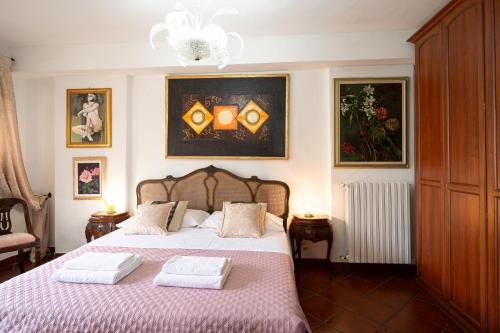 a bedroom with a bed with two towels on it at Into the Green! Imperia Appt with Parking & Pool in Barcheo