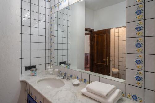 a bathroom with a sink and a mirror at Into the Green! Imperia Appt with Parking & Pool in Barcheo