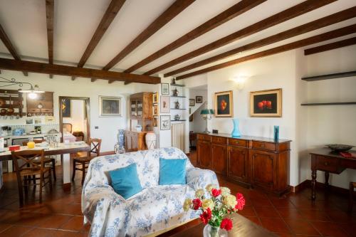a living room with a couch and a table at Into the Green! Imperia Appt with Parking & Pool in Barcheo