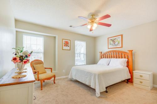 a bedroom with a bed and a ceiling fan at Central and Spacious Townhome in Greensboro! in Greensboro