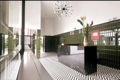 a lobby with a vase of flowers on a counter at Cómodo y silencioso Apartamento 1BR en Barranco in Lima