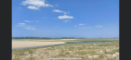 a view of a field with a river and sky at Haven Church Farm in Pagham