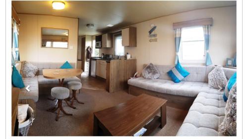 a living room with a couch and a table at Haven Church Farm in Pagham