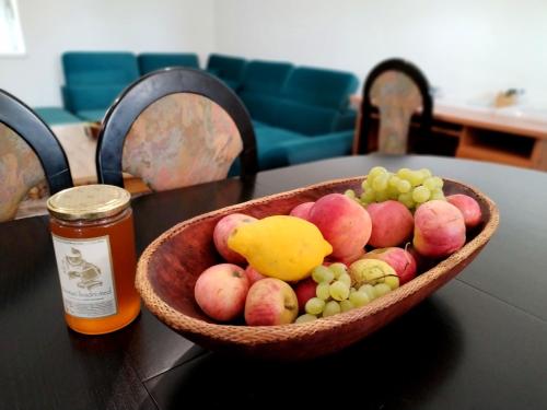 a bowl of apples and grapes on a table at Tone in Ogulin