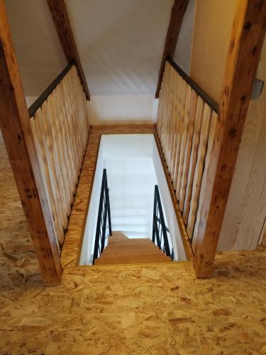 a window in the ceiling of a room with wooden beams at Tone in Ogulin