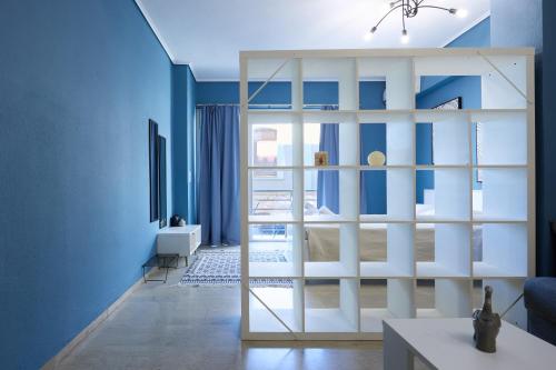 a living room with blue walls and a sliding glass door at Chios Downtown Apartments in Chios