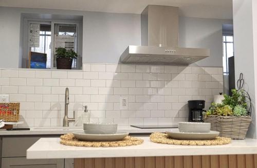 a kitchen counter with two dishes on top of it at One bedroom apartment with AC and WiFi in the Bronx in Williams Bridge
