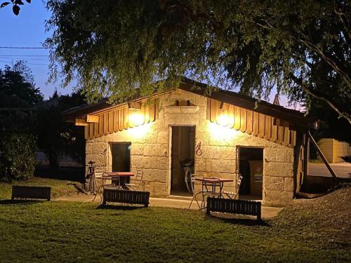 a stone building with benches in a park at night at Gite Gauriaguet in Gauriaguet