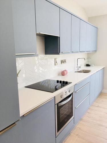 a white kitchen with white cabinets and a sink at Stunning home from home in Waterford