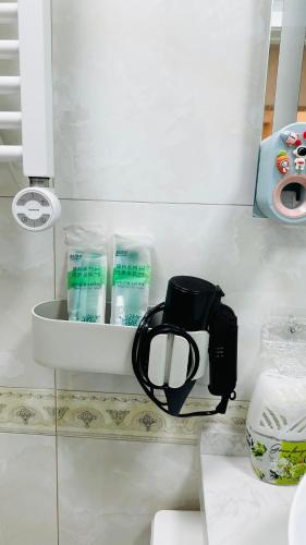 a bathroom with a shelf with toiletries on it at National Stadium-Naadam Center-Tsengeldekh apartment in Ulaanbaatar