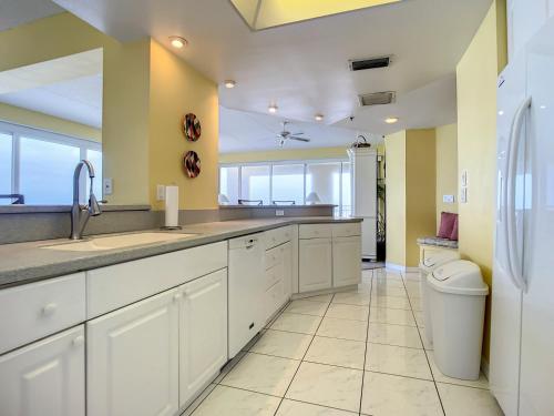 a large kitchen with a sink and a toilet at Penthouse Condo with wrap around views of the ocean - SR802 in Edgewater