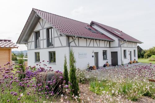 a house with a garden in front of it at Binzighof Ferienhäuser in Oberkirch