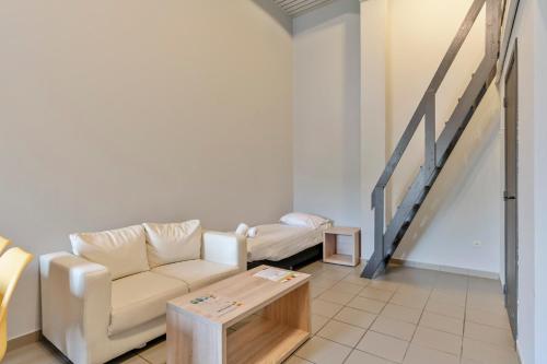 a living room with a couch and a table at Budget Flats Leuven in Leuven