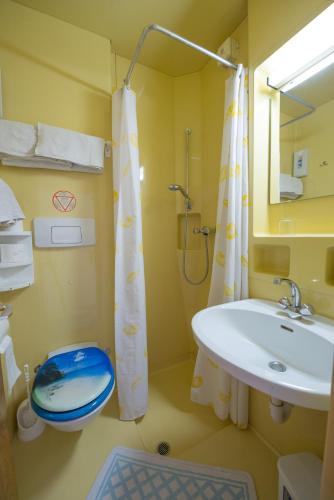 a bathroom with a sink and a toilet and a shower at Casa Alessandra in Malcesine
