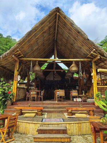a large pavilion with chairs and tables and chairs at YAY Sustainable in Guachaca