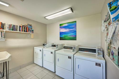 a laundry room with three washers and dryers at Pool Access and Lanai Riverfront Welaka Condo! in Georgetown