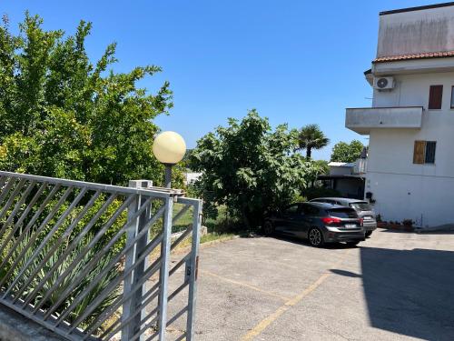 a car parked in a parking lot next to a building at Il verdino in Marcelli