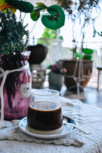 a cup of coffee on a plate on a table at Imah Seuri by Kaya Rooms in Tutugan