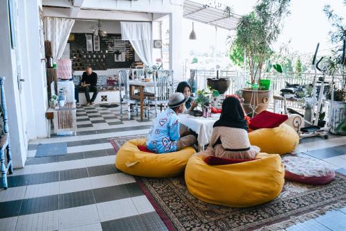 a group of people sitting on bean bags on the floor at Imah Seuri by Kaya Rooms in Tutugan
