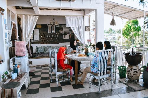 a group of people sitting at a table at Imah Seuri by Kaya Rooms in Tutugan