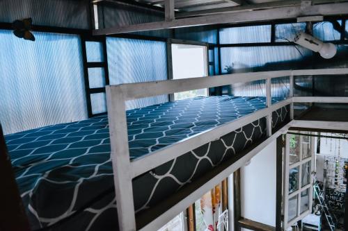 a bunk bed in a room with windows at Imah Seuri by Kaya Rooms in Tutugan