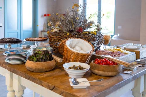a table with a buffet of food on it at Planeta Country House & Beach Club in Menfi