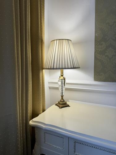 a lamp sitting on top of a table at Royal Grand Hotel in Kyiv