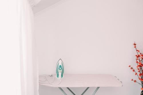 a iron sitting on a shelf next to a window at Apartments in Uzhgorod in Uzhhorod