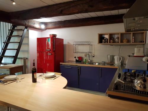 a kitchen with a red refrigerator and a wooden table at Residenza Ticino in Intra