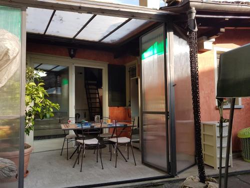 a patio with a table and chairs on it at Residenza Ticino in Intra