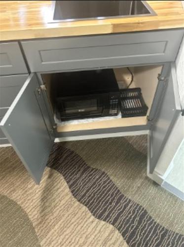 a desk with a drawer with a keyboard and a remote control at The Silverwood Lodge in Athol