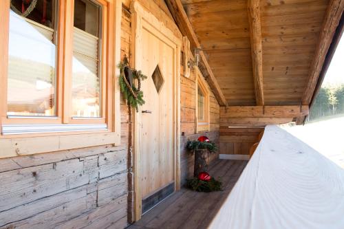 a porch of a log cabin with a window at Apartment Steger in Mittersill