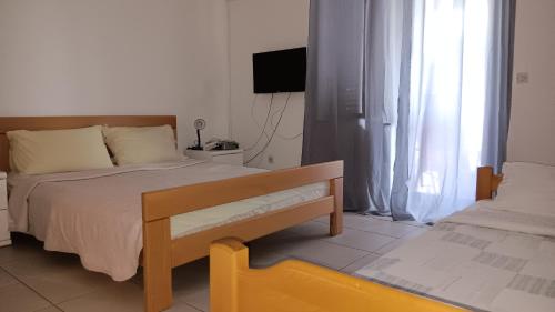 a bedroom with a bed and a tv in a room at Apartman Tatjana in Senj