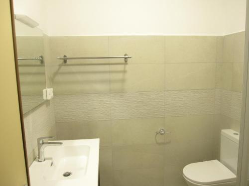 a bathroom with a sink and a toilet at Argea in Grado