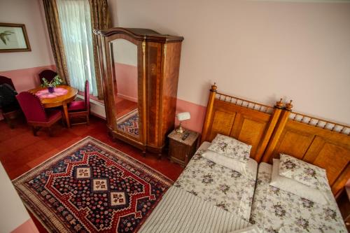 a living room with a bed and a mirror at Nina Kordon Guesthouse in Alatskivi