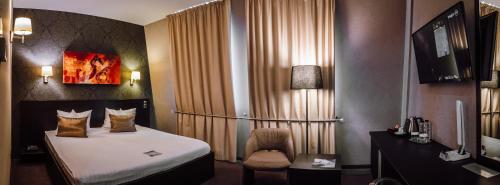 Ένα ή περισσότερα κρεβάτια σε δωμάτιο στο Plaza V Executive Hotel