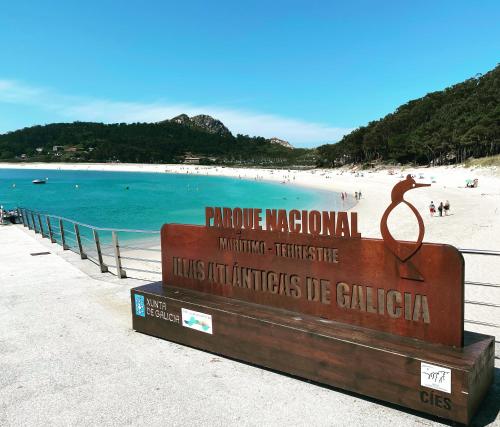 a sign on a beach with people on the beach at Villa Papona 1 in Moaña