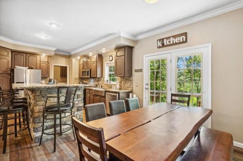 a kitchen with a wooden table and chairs at Red Bear Run in Beech Mountain