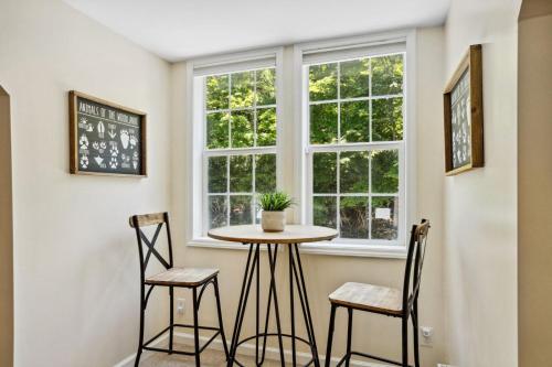a small table and two chairs in a room with a window at Red Bear Run in Beech Mountain