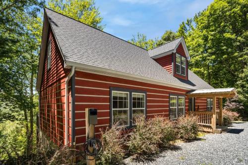 a red house with a gambrel roof at Red Bear Run in Beech Mountain