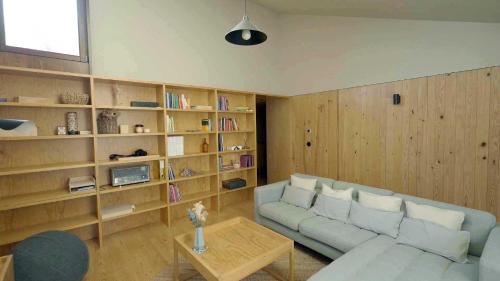 a living room with a couch and book shelves at Natura Natura in Paredes